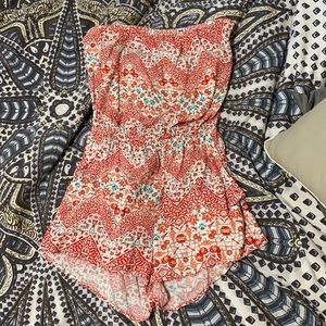 Adorable strapless open back romper with pockets